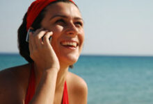 Une femme au téléphone portable à la plage